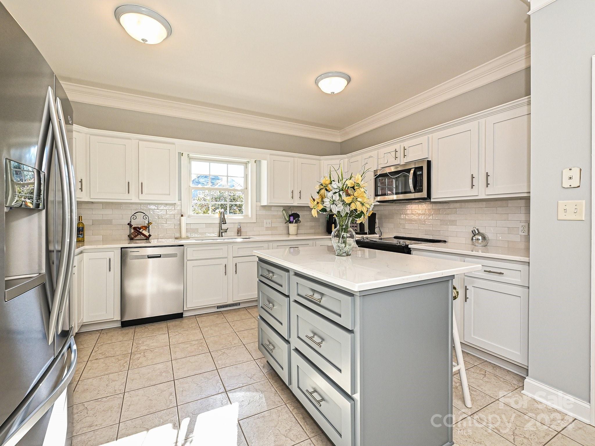 3203 Bentley Drive Lancaster, SC 29720 - Photo 17 of 45 a kitchen with a sink a stove a refrigerator and white cabinets