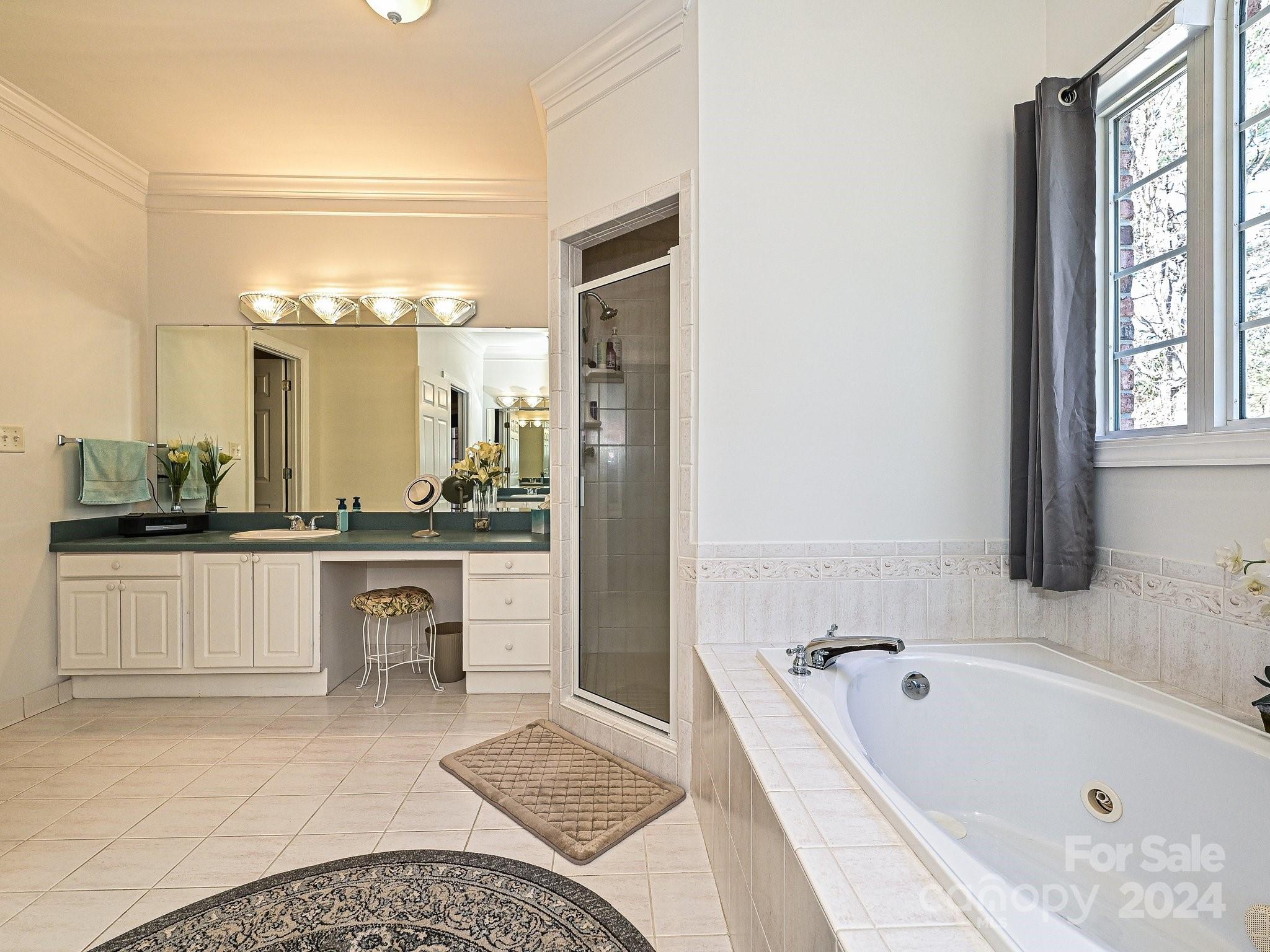 3203 Bentley Drive Lancaster, SC 29720 - Photo 25 of 45 a bathroom with a tub a double vanity sink and a large mirror