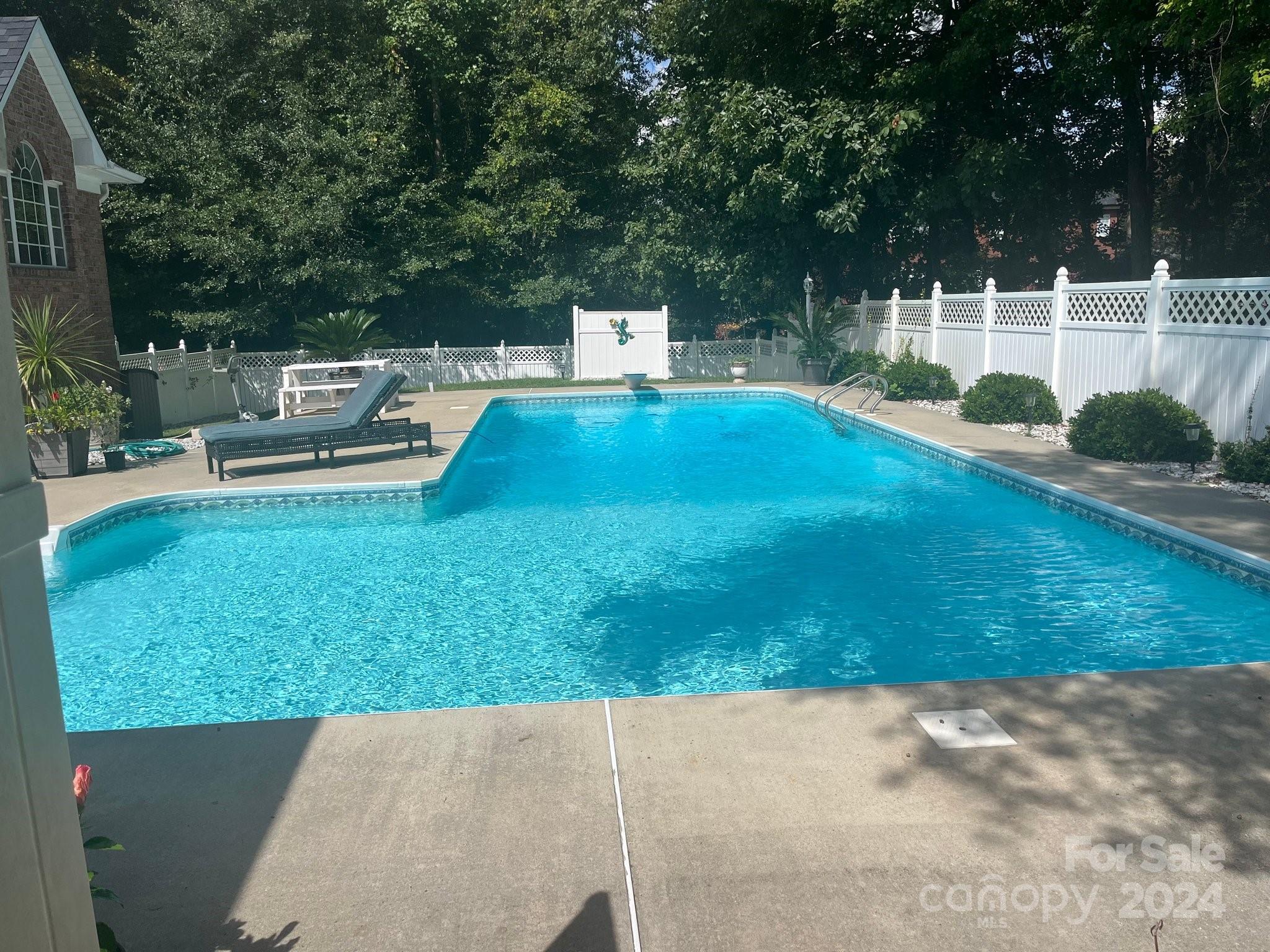 3203 Bentley Drive Lancaster, SC 29720 - Photo 41 of 45 a view of a patio with table and chairs potted plants with wooden fence