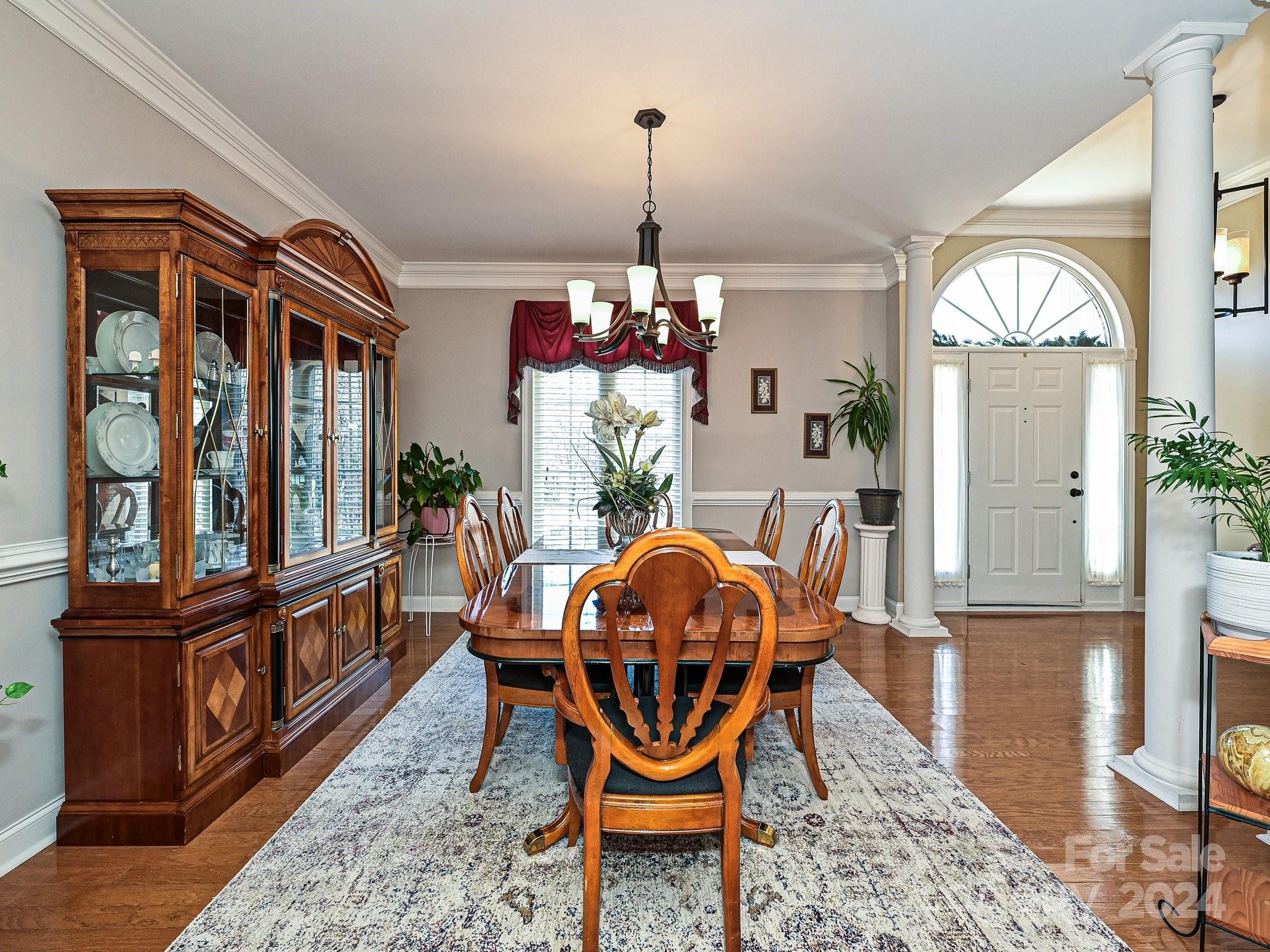 3203 Bentley Drive Lancaster, SC 29720 - Photo 7 of 45 a dining room with furniture a rug and a chandelier