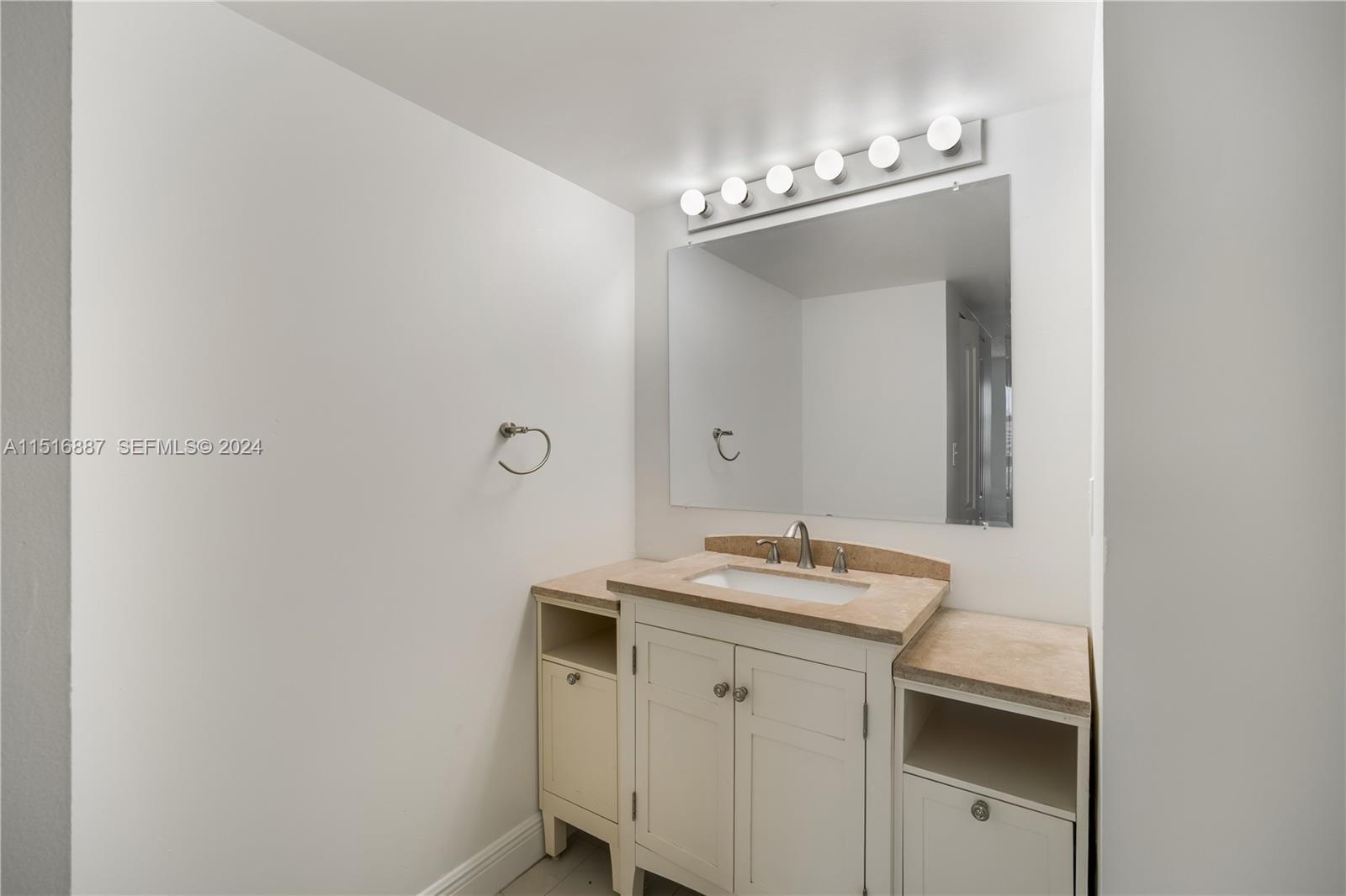 2351 Douglas Road, Unit 1207 Miami, FL 33145 - Photo 13 of 22 a bathroom with a sink and a mirror