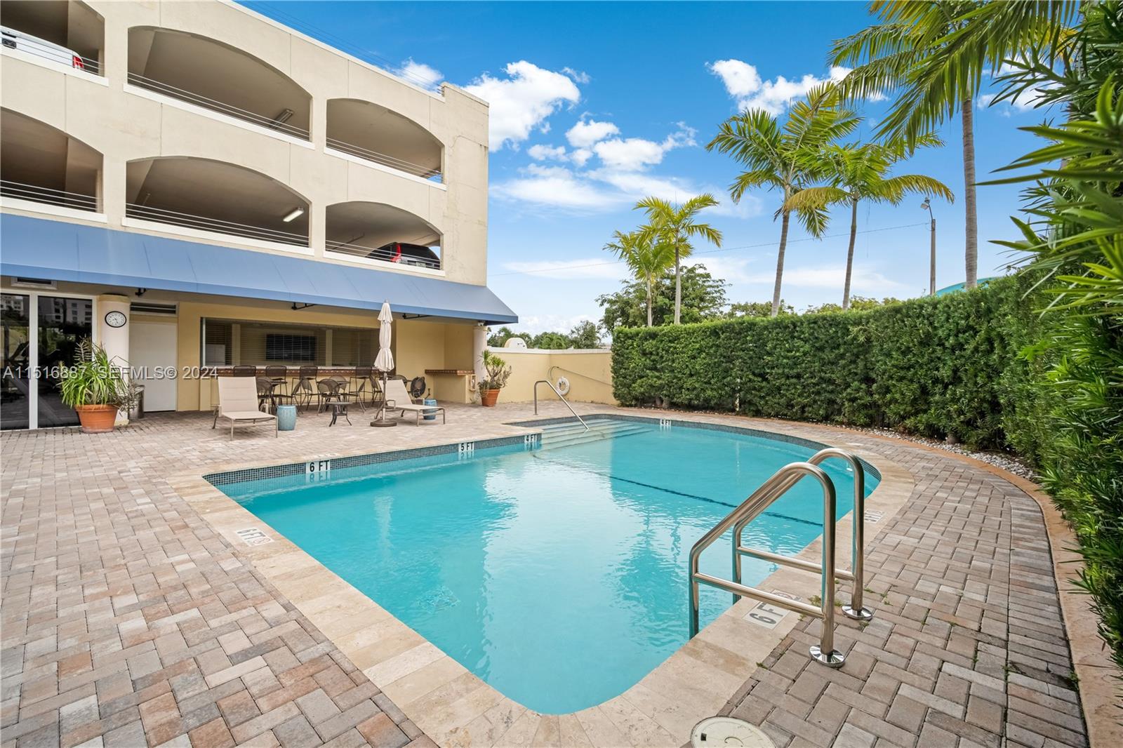 2351 Douglas Road, Unit 1207 Miami, FL 33145 - Photo 19 of 22 a view of a swimming pool with a patio