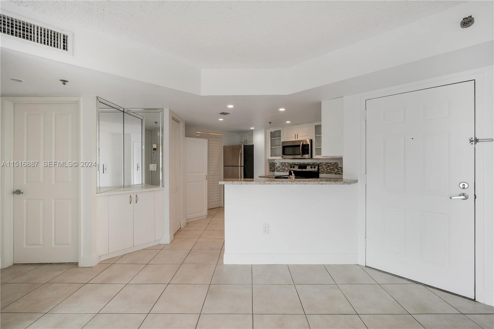 2351 Douglas Road, Unit 1207 Miami, FL 33145 - Photo 5 of 22 a view of kitchen with refrigerator and cabinets