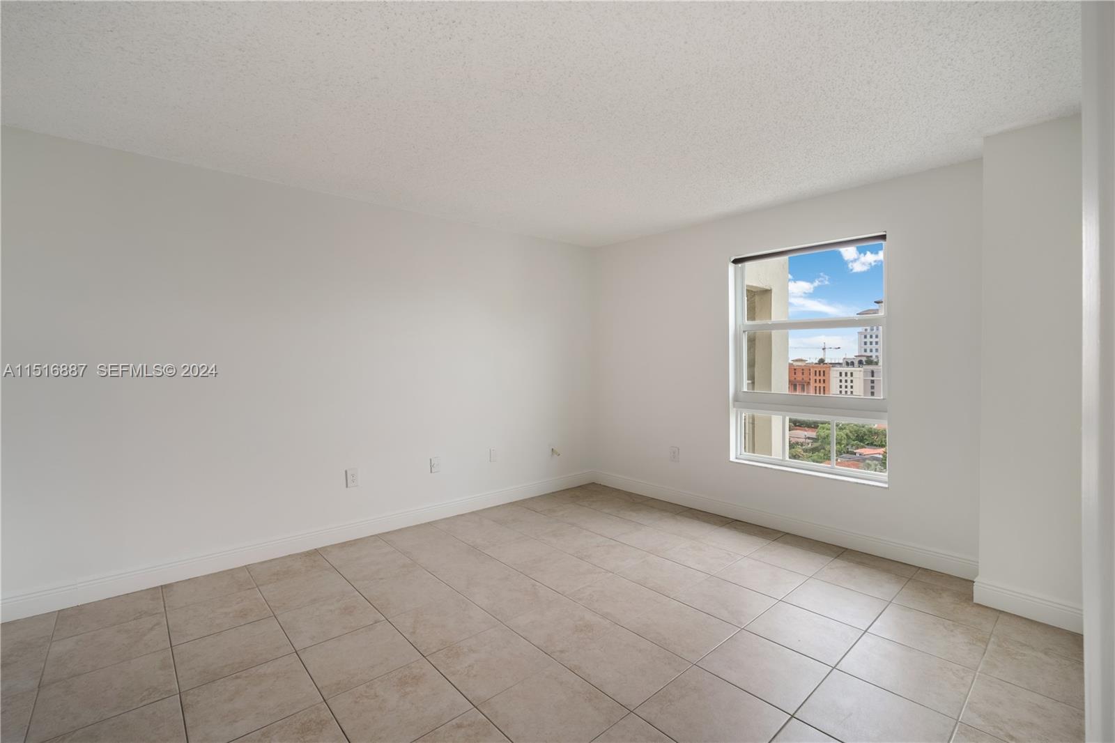 2351 Douglas Road, Unit 1207 Miami, FL 33145 - Photo 9 of 22 an empty room with windows