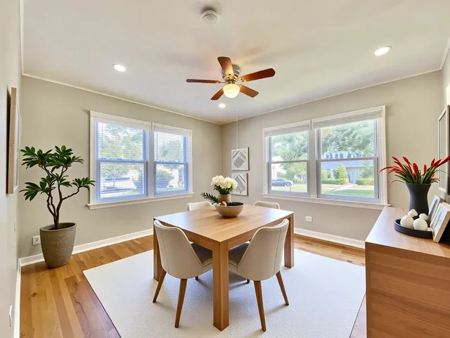 a dining room with furniture potted plants and wooden floor