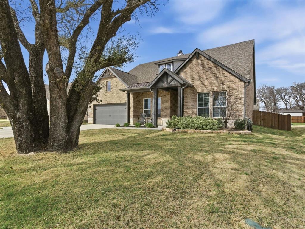 1117 Springfield Road Springtown, TX 76082 - Photo 1 of 40 a front view of a house with garden