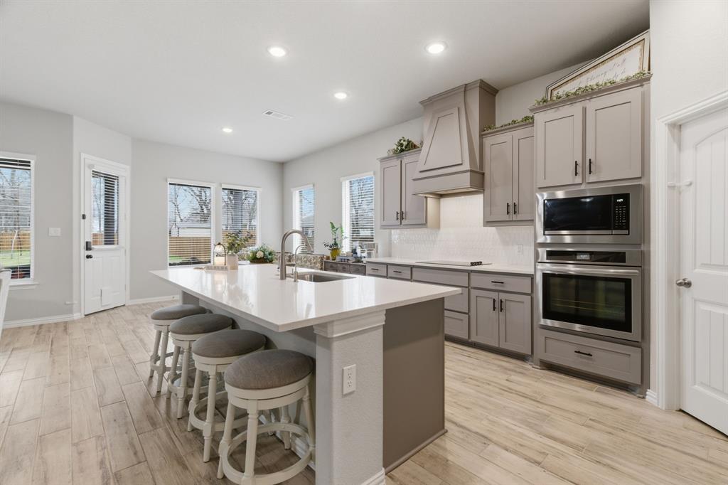 1117 Springfield Road Springtown, TX 76082 - Photo 13 of 40 a kitchen with stainless steel appliances a sink stove and cabinets