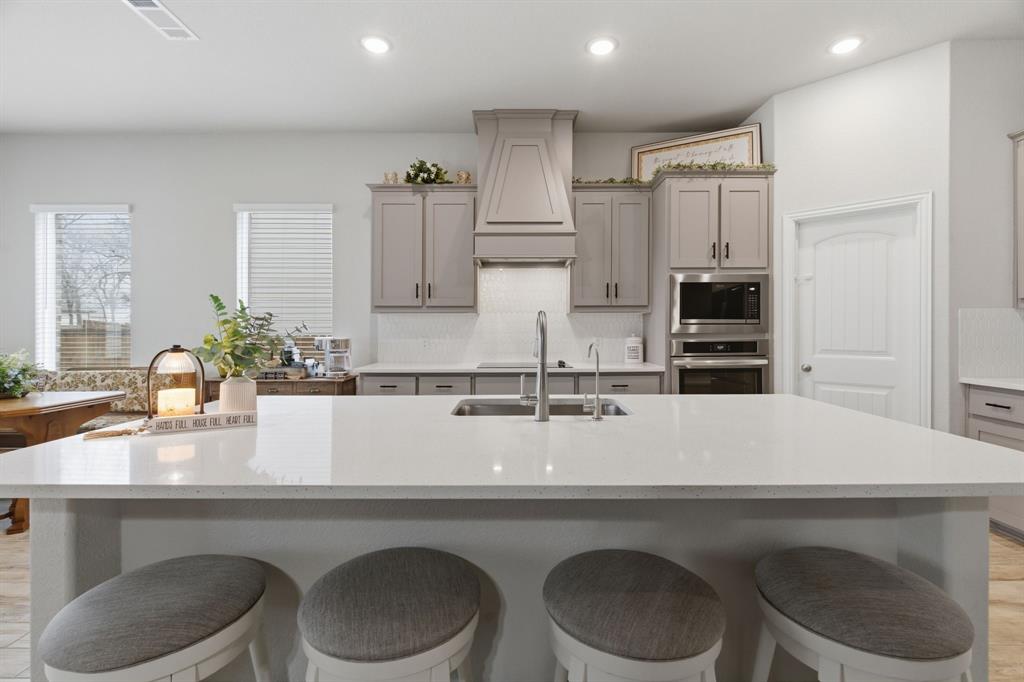 1117 Springfield Road Springtown, TX 76082 - Photo 14 of 40 a kitchen with a sink a table and chairs