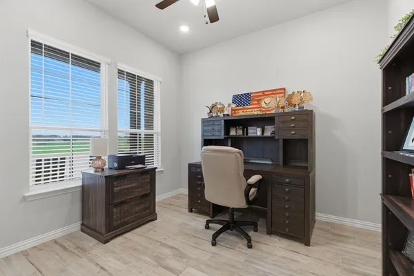 a view of a workspace with furniture and a window