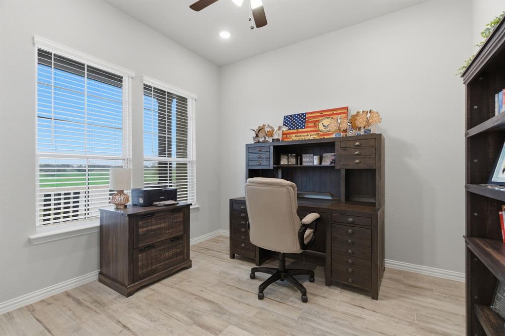 1117 Springfield Road Springtown, TX 76082 - Photo 16 of 40 a view of a workspace with furniture and a window