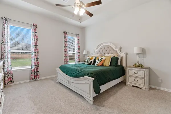 a bedroom with a bed and a chandelier