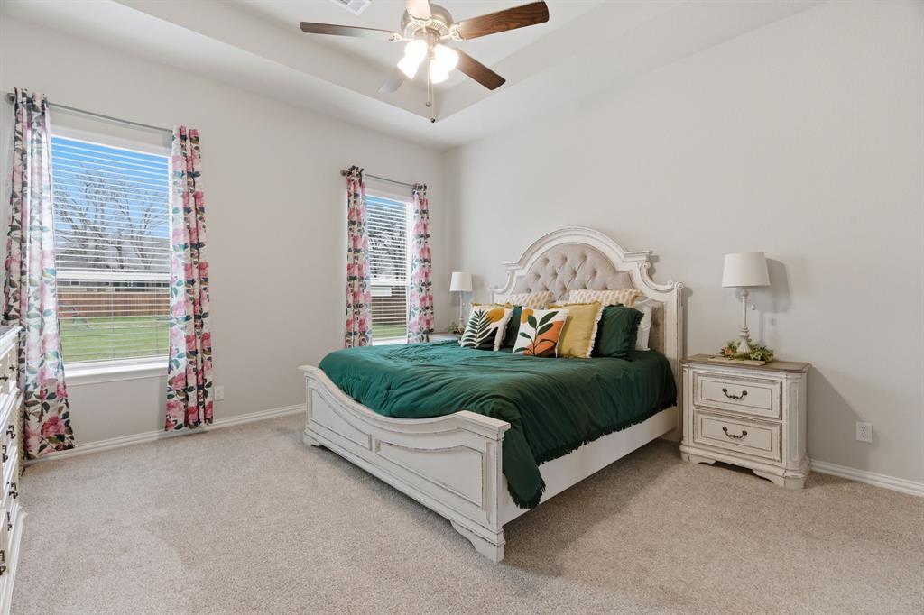 1117 Springfield Road Springtown, TX 76082 - Photo 18 of 40 a bedroom with a bed and a chandelier