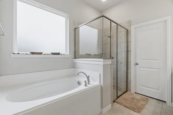 a bathroom with a bathtub and a window