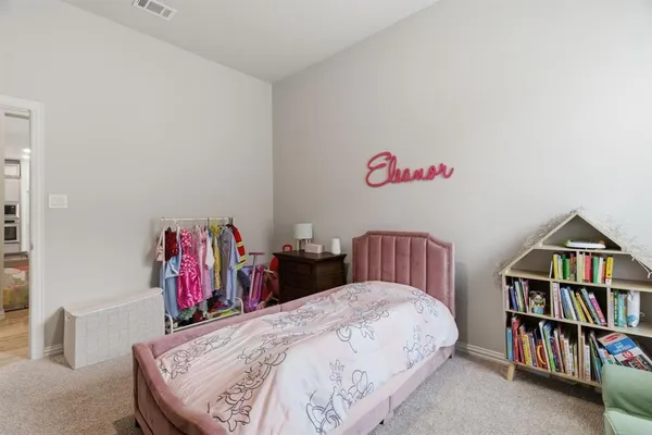 a bed room with a bed and a book shelf