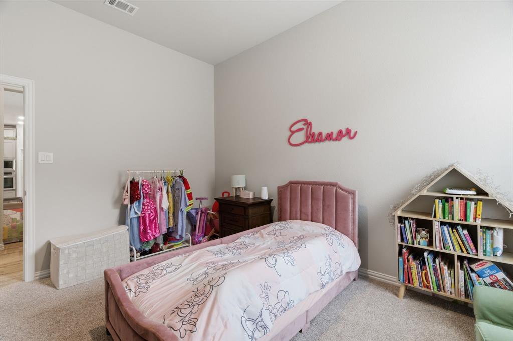 1117 Springfield Road Springtown, TX 76082 - Photo 23 of 40 a bed room with a bed and a book shelf