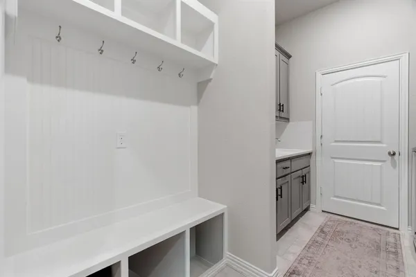 a kitchen with white cabinets and white appliances