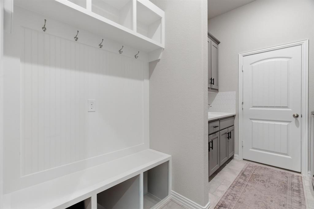 1117 Springfield Road Springtown, TX 76082 - Photo 28 of 40 a kitchen with white cabinets and white appliances