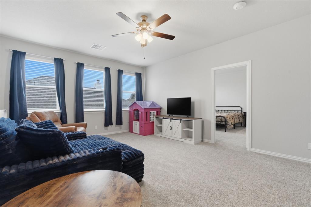 1117 Springfield Road Springtown, TX 76082 - Photo 31 of 40 a bedroom with a bed and a flat tv screen on the dresser