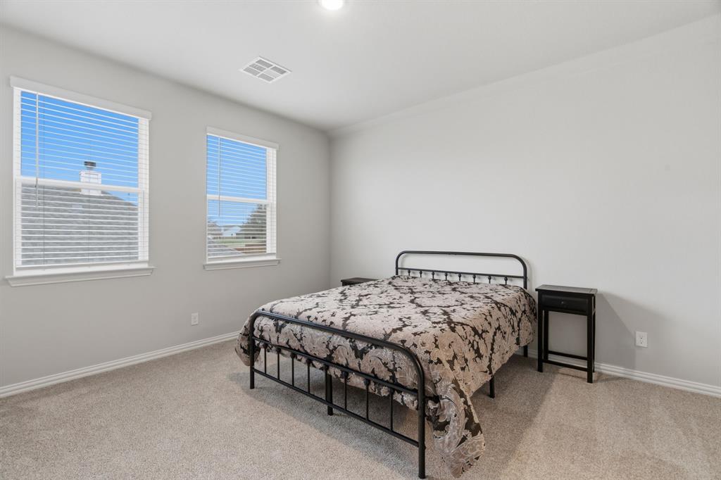 1117 Springfield Road Springtown, TX 76082 - Photo 32 of 40 a bedroom with a bed and window