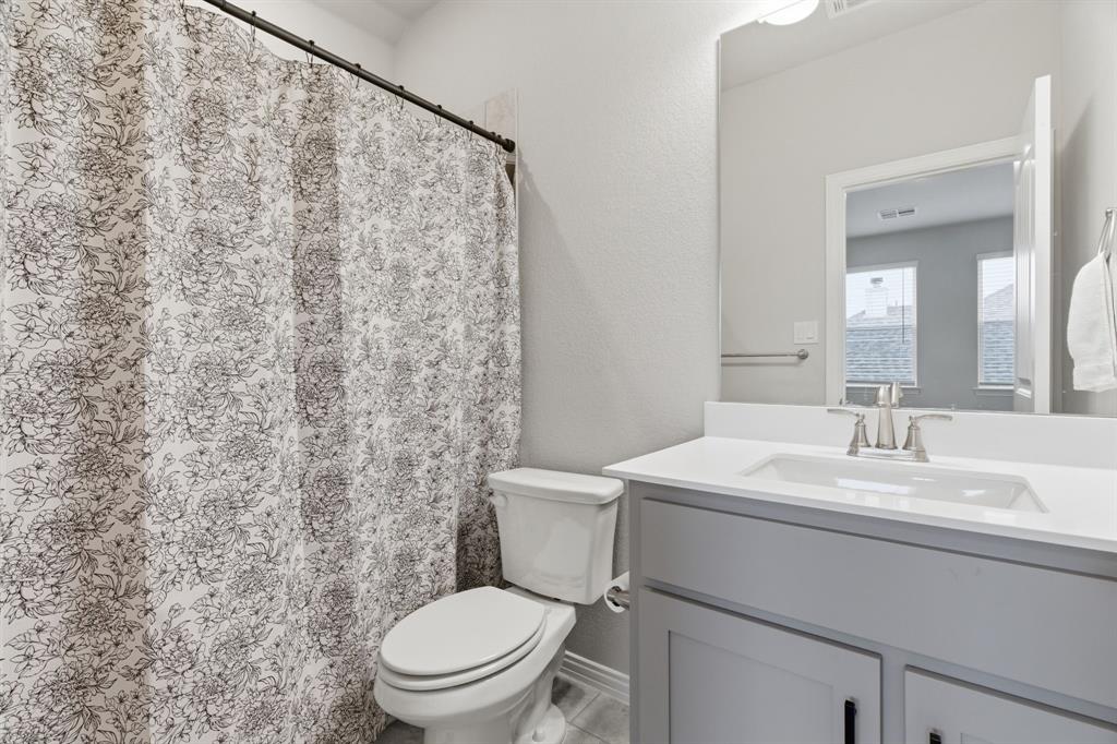 1117 Springfield Road Springtown, TX 76082 - Photo 33 of 40 a bathroom with a sink a toilet and a mirror