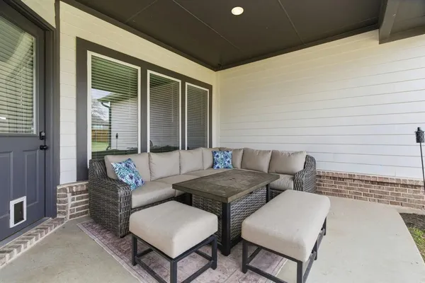 a view of a patio with couches and a table and chairs