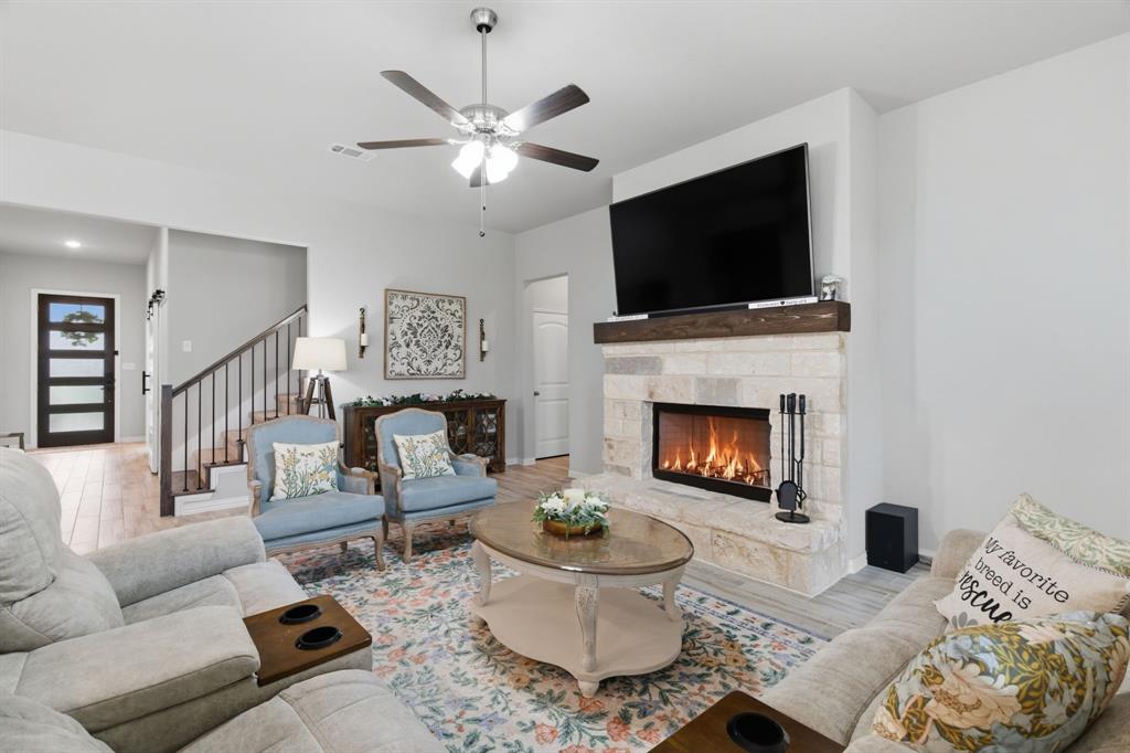 1117 Springfield Road Springtown, TX 76082 - Photo 9 of 40 a living room with furniture a flat screen tv and a fireplace