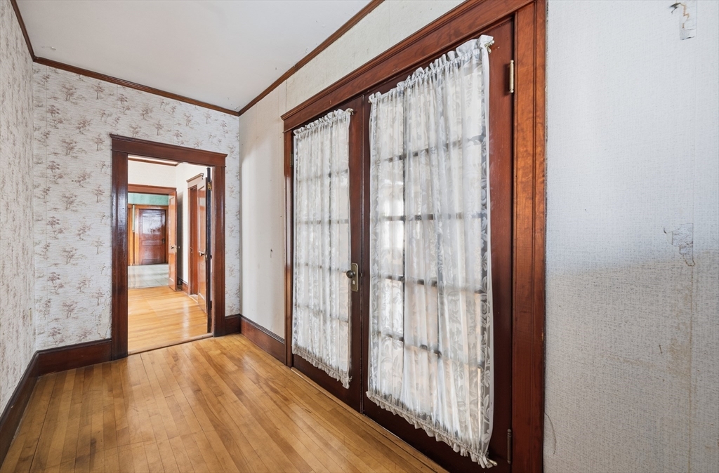 47 Houghton Street Worcester, MA 01604 - Photo 14 of 39 a view of a room with wooden floor and windows