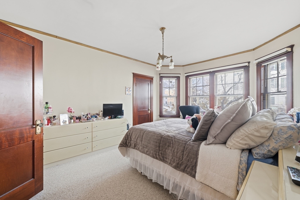 47 Houghton Street Worcester, MA 01604 - Photo 15 of 39 a spacious bedroom with a bed and window