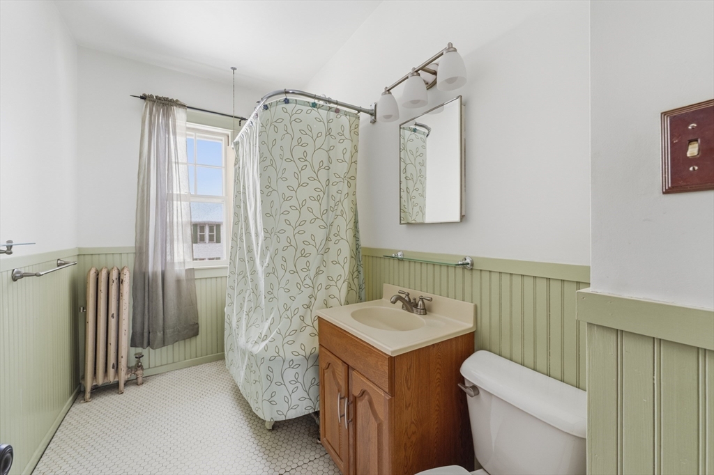 47 Houghton Street Worcester, MA 01604 - Photo 20 of 39 a bathroom with a toilet sink and shower