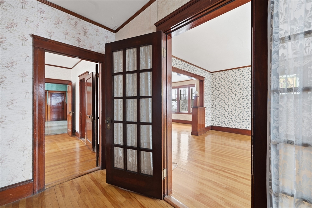 47 Houghton Street Worcester, MA 01604 - Photo 31 of 39 a view of a hallway with wooden floor and staircase