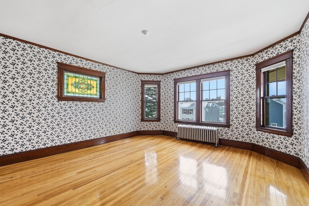 47 Houghton Street Worcester, MA 01604 - Photo 34 of 39 a view of an empty room with a window and wooden floor