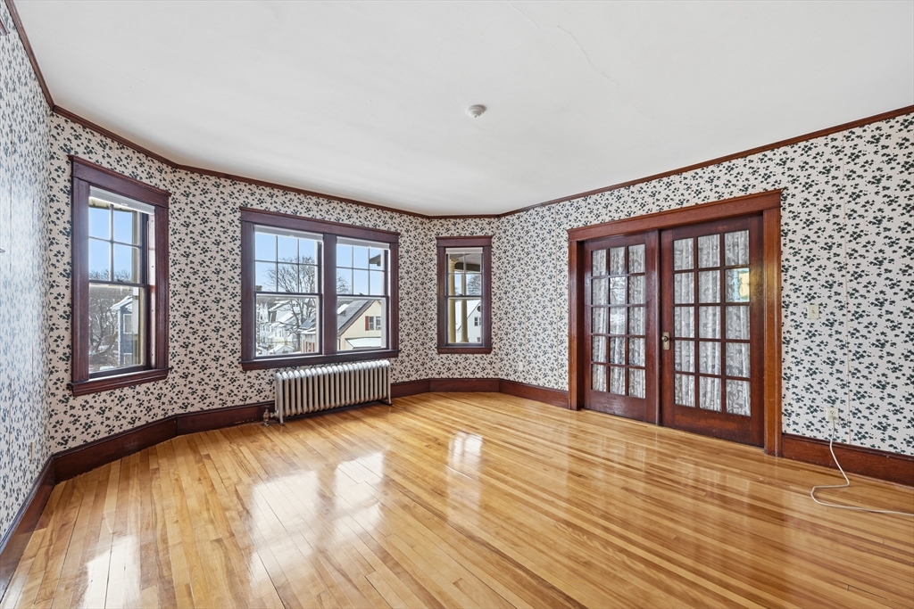 47 Houghton Street Worcester, MA 01604 - Photo 35 of 39 a view of an empty room with a window and wooden floor