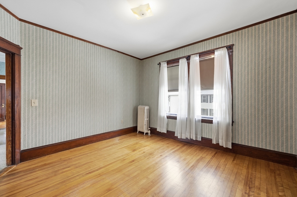 47 Houghton Street Worcester, MA 01604 - Photo 39 of 39 an empty room with wooden floor and windows