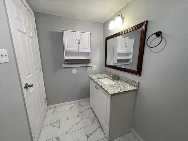 a utility room with cabinets washer and dryer