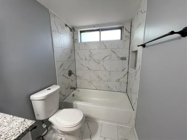 a bathroom with a toilet and a shower