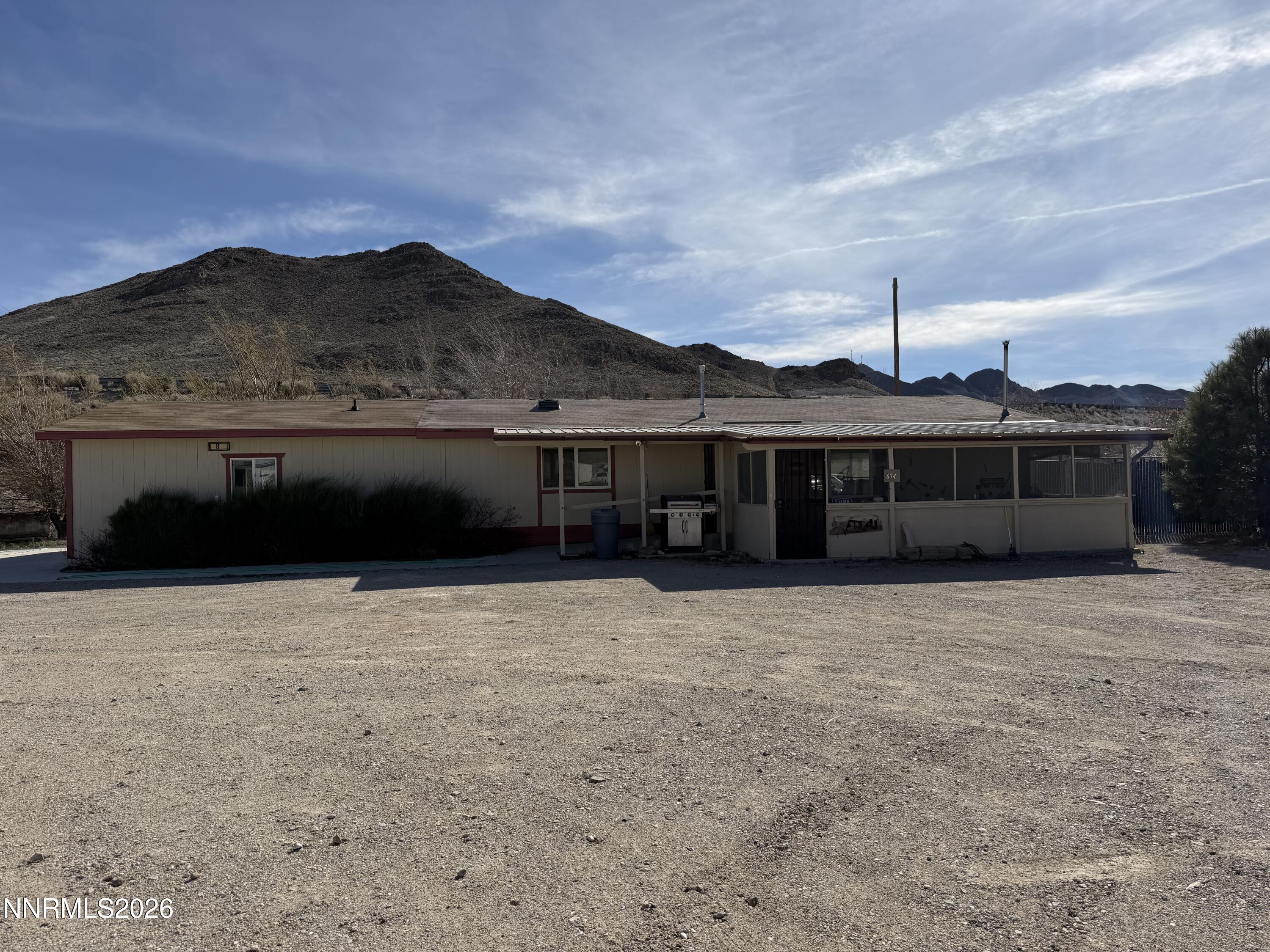 6 Ketten Road Tonopah, NV 89049 - Photo 1 of 49 a front view of a house with a yard and mountain view