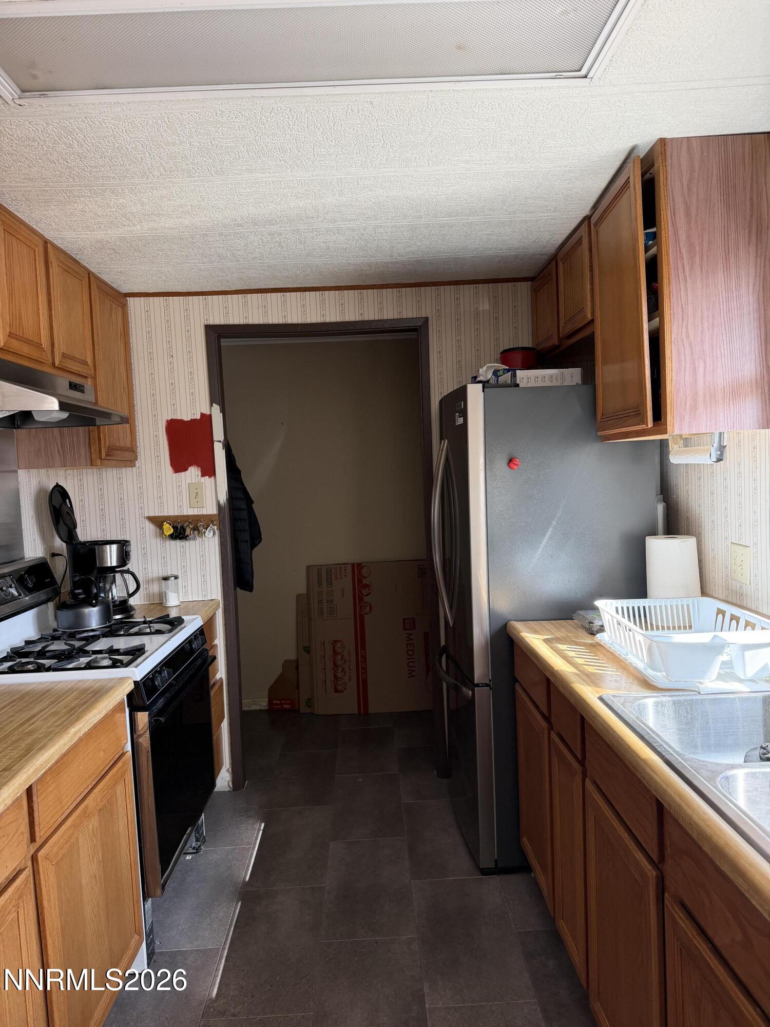 6 Ketten Road Tonopah, NV 89049 - Photo 4 of 49 a kitchen with stainless steel appliances granite countertop a sink stove and refrigerator