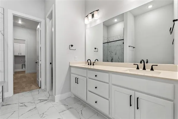 a spacious bathroom with double sink and a mirror