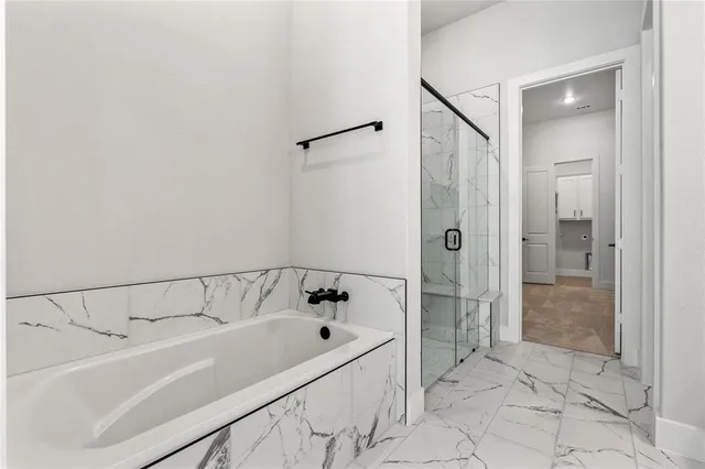 a bathroom with a bathtub and a shower