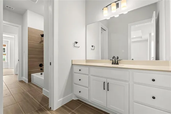 a bathroom with a double vanity sink a mirror and a shower