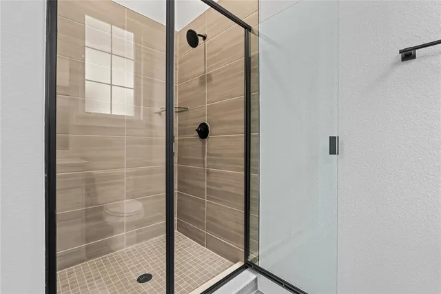 a bathroom with a glass shower door