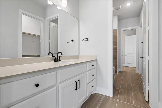 a spacious bathroom with double sink and mirror