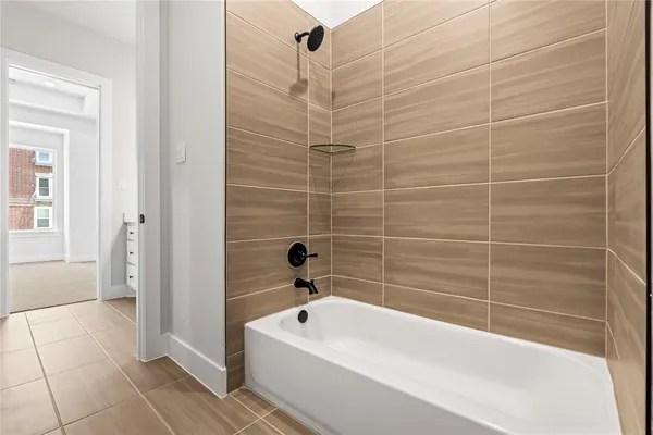 a bathroom with a white bathtub and shower