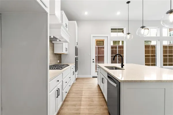 a large white kitchen with a large window