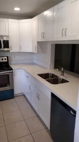 a kitchen with cabinets and appliances