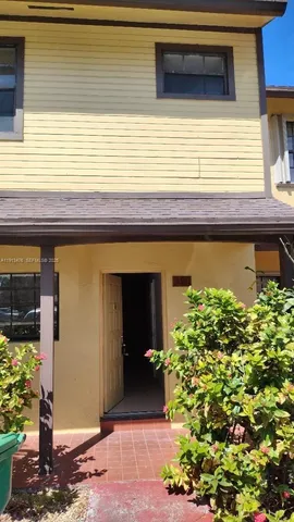 a view of a house with a door and wooden floor