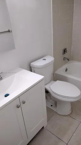 a white toilet sitting next to a bathroom sink