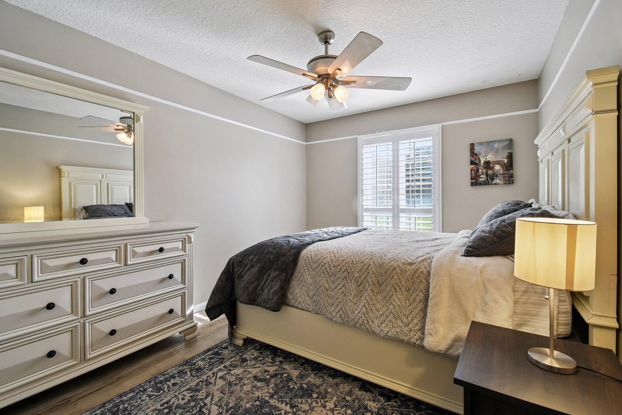 1220 Creek Bend Road Jacksonville, FL 32259 - Photo 16 of 30 a bedroom with a bed and dresser with mirror