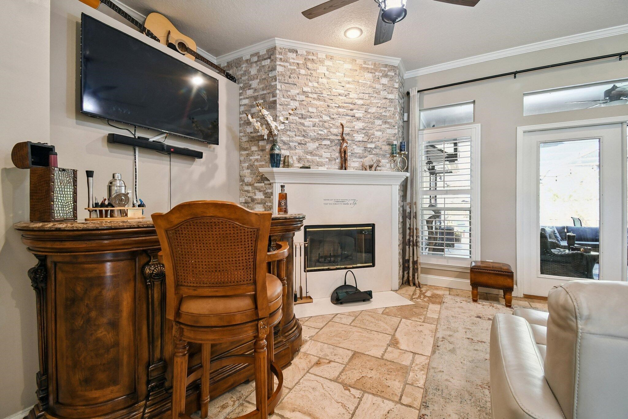 1220 Creek Bend Road Jacksonville, FL 32259 - Photo 23 of 30 a living room with furniture a flat screen tv and a fireplace