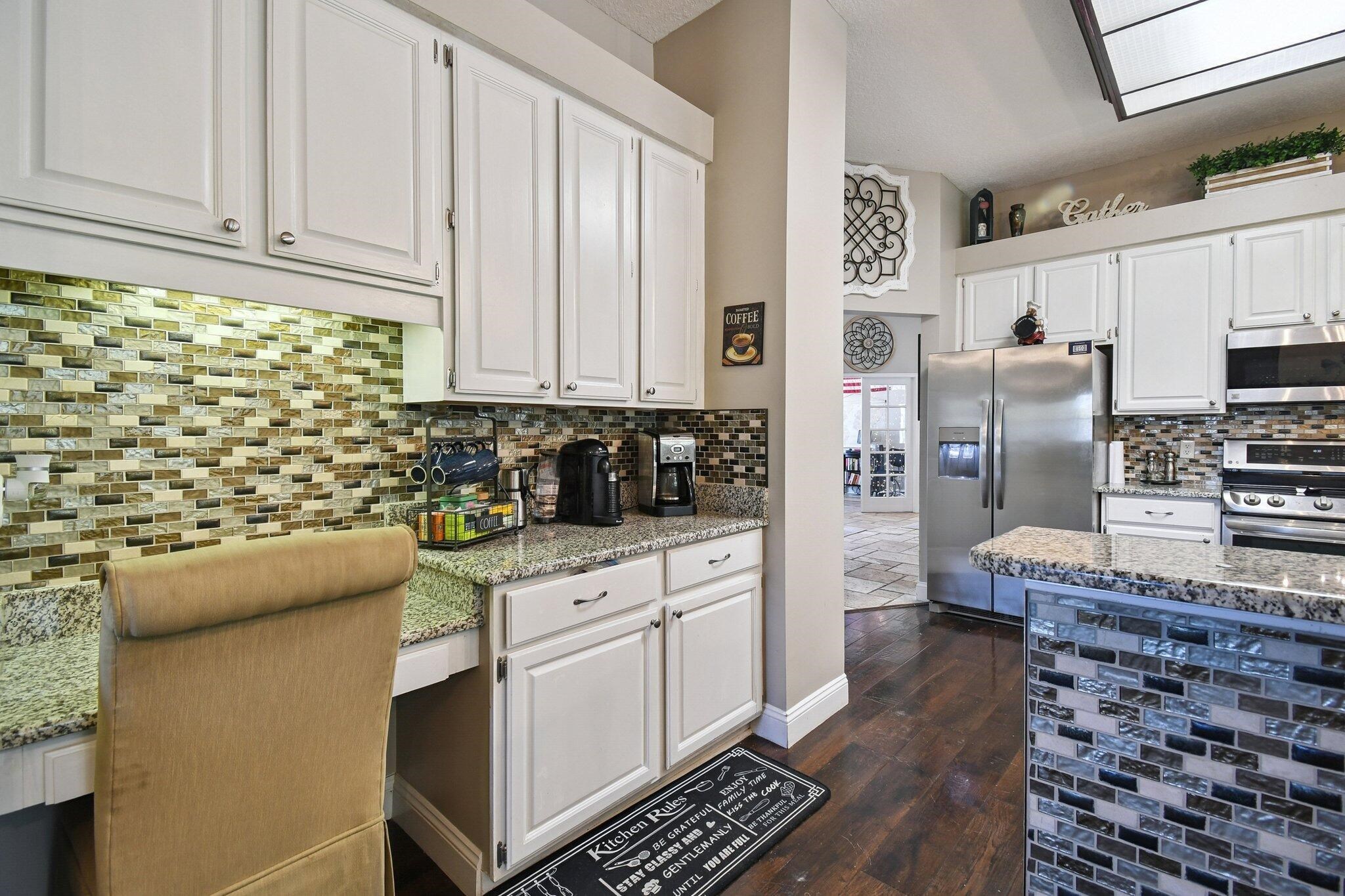1220 Creek Bend Road Jacksonville, FL 32259 - Photo 8 of 30 Kitchen featuring white cabinets, stainless steel appliances, light stone counters, and dark wood finished floors